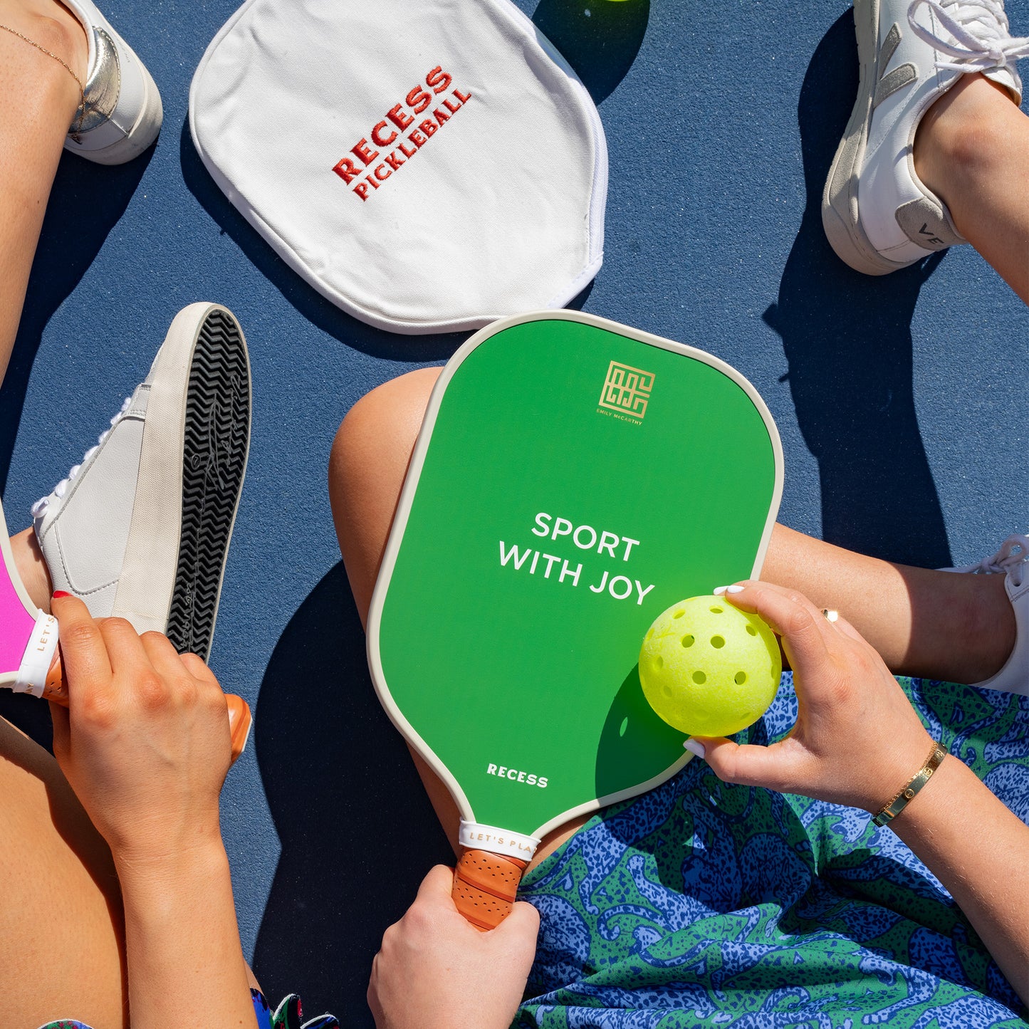 A selection of Recess pickleball paddles displayed on a court