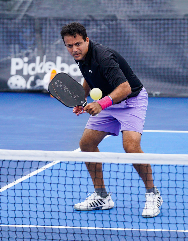 A pro pickleball player, like Matt Wright or Lucy Kovalova, using an Onix Malice or Mayhem paddle in a match